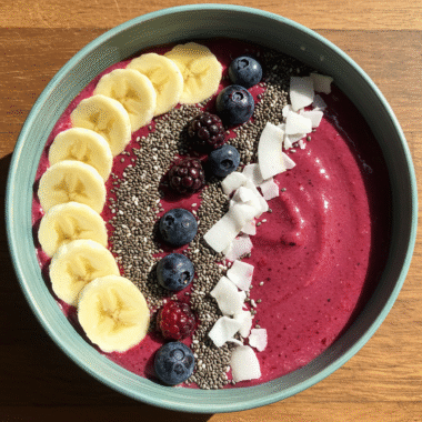 Vibrant smoothie bowl topped with banana, chia, and coconut